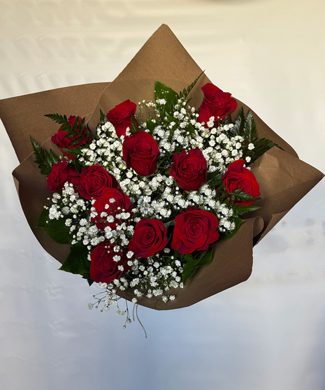 Hand-wrapped bouquet of 12 long-stem Ecuadorian roses in assorted colors accented with baby’s breath, lemon leaf, and leather leaf